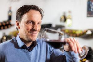 Leiter des Weinseminars mit einem Rotwein
